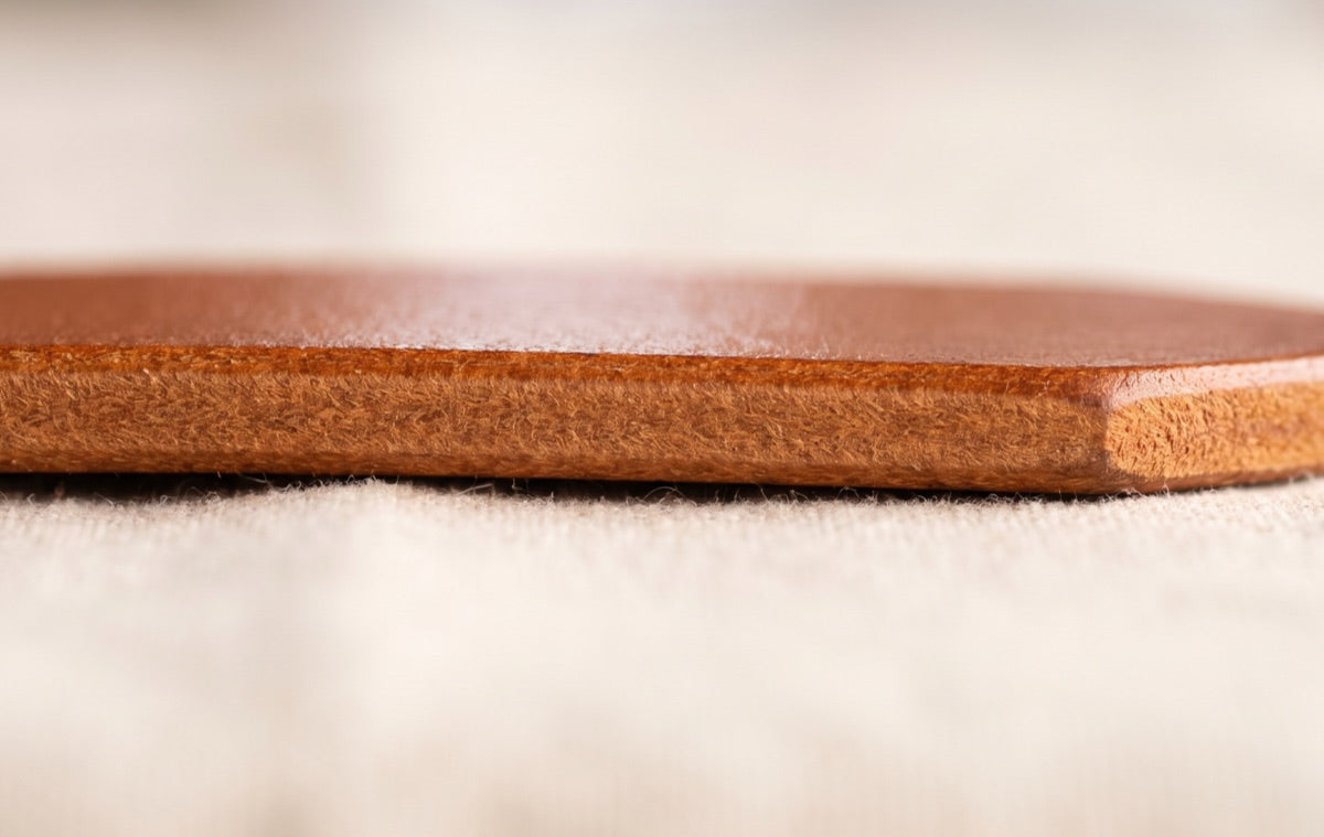 The edge of a full-grain leather belt: one solid piece of hide