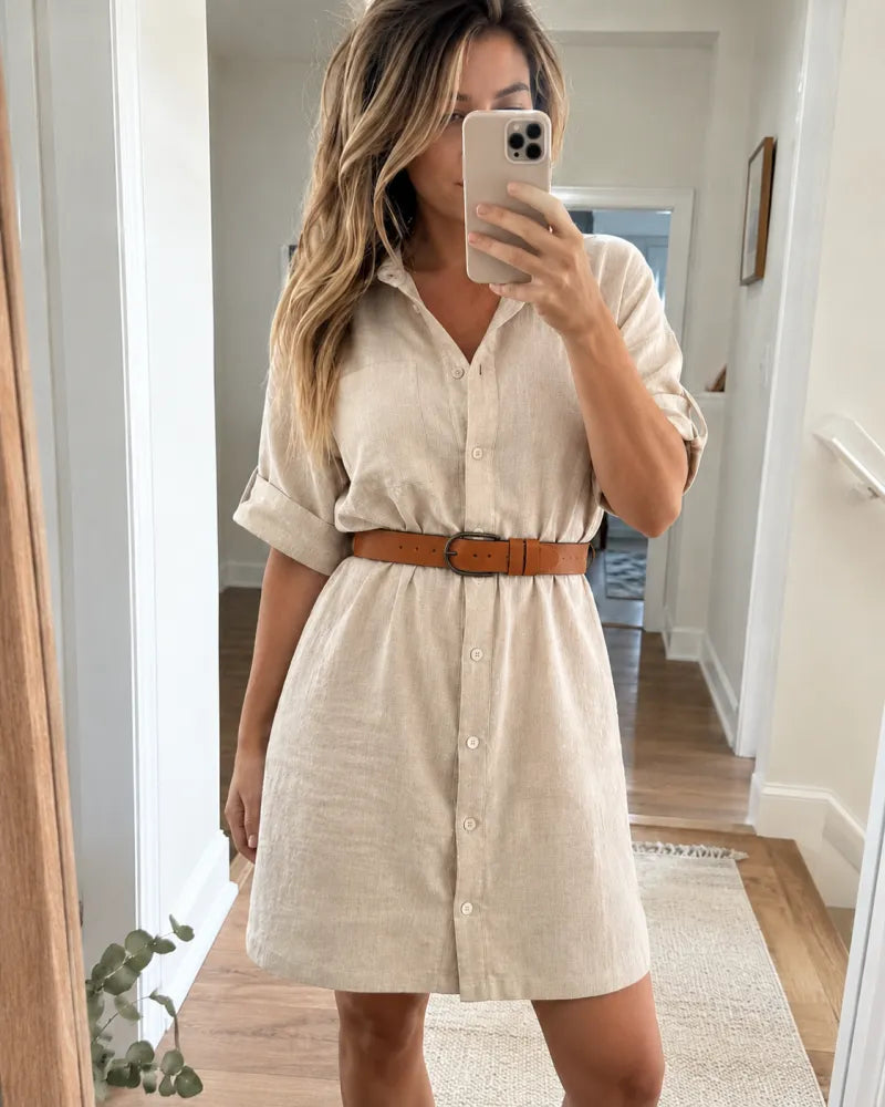 Beige linen shirt dress cinched with a tan leather belt