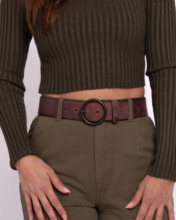 Wine Pip belt with an olive knit and trousers