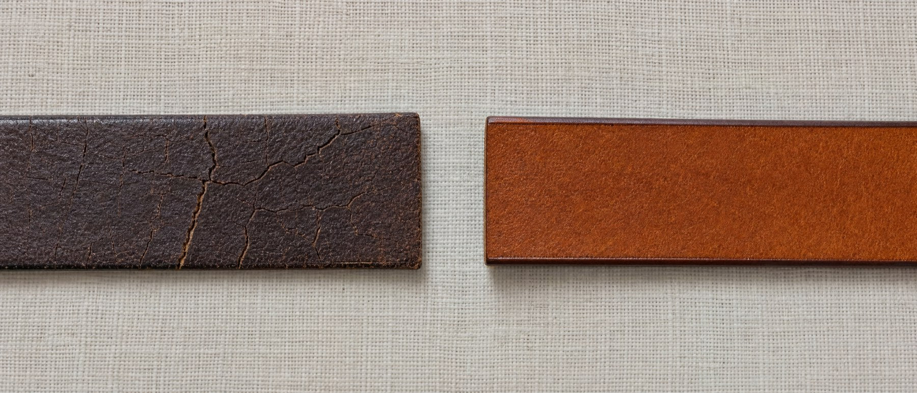 Two belt straps side by side: a cracked, dried-out coated belt on the left, a sound full-grain leather belt on the right